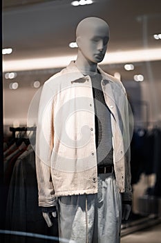 Male mannequins in a men's store in store window show autumn winter collection . Standing men dummies show casual style collectio