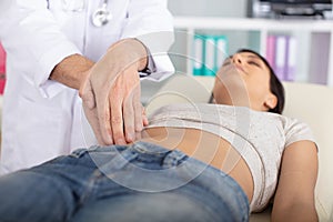 male masseur makes visceral massage internal organs