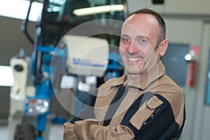 Male mature worker smiling in warehouse