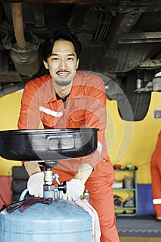 Male mechanic engineering working under Vehicle in Car Service