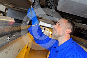 Male mechanic fixing vehicle