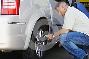 Male Mechanic Inflating RV Tire