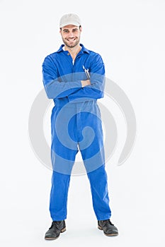 Male mechanic standing arms crossed on white background