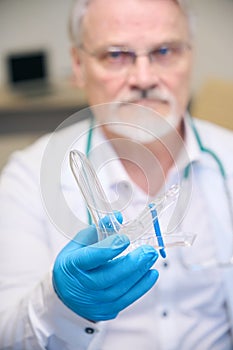 Male medic holding medical instrument in hospital