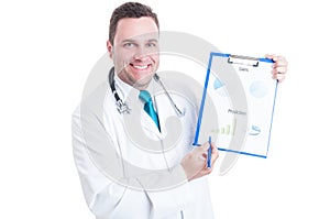 Male medic smiling and showing prediction statistics on clipboard