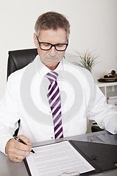 Male Medical Doctor Signing Document