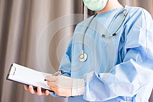 Male medicine doctor hand holding pen writing something on clipboard closeup. Medical care, insurance, prescription, paper work o