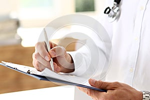 Male medicine doctor hand holding silver pen and clipboard