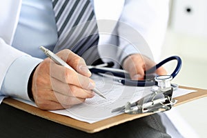 Male medicine doctor hand holding silver pen writing