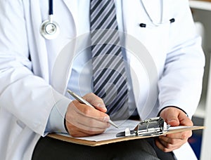 Male medicine doctor hand holding silver pen writing