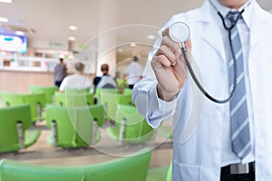 Male medicine doctor hand holding stethoscope with patient waiting room background, Healthcare and Midical concepts