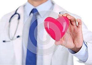 Male medicine doctor hands holding red toy heart