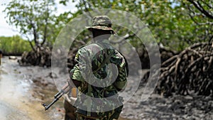 Male member of the military forces in Mocimboa da Praia, located in the Cabo Delgado region photo