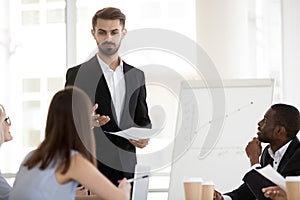 Male mentor, coach with paper in hands holding business briefing