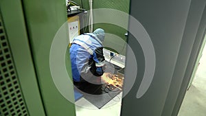 Male metal worker polishing piece of medieval armour suit