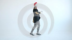 Male mime performer dancing gesturing looking at camera on white background