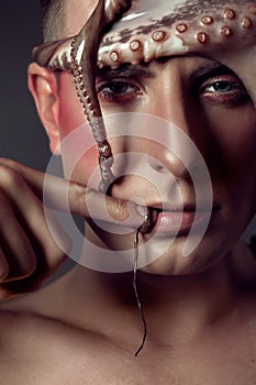 Male model close up portrait with make up and octopus, sea life concept