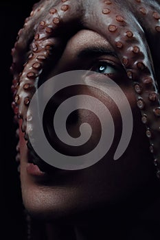 Male model close up portrait with make up and octopus, sea life concept