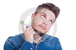 Male model cooling his neck with cold water bottle