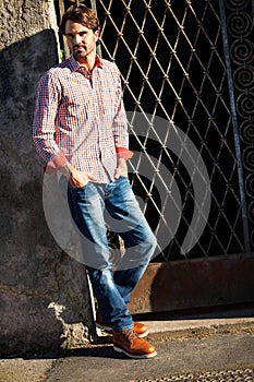 Male model leaning against wall