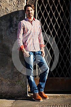 Male model leaning against wall