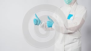 Male model in PPE suite and face mask doing two thumbs up  hand sign on white background
