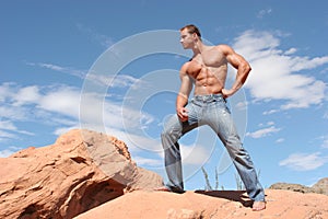 male model with sixpack abs in blue jeans