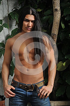 Male model in tropical greenhouse
