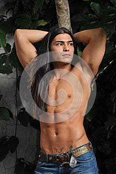 Male model in tropical greenhouse