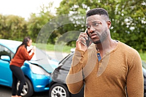 Male Motorist Involved In Car Accident Calling Insurance Company Or Recovery Service