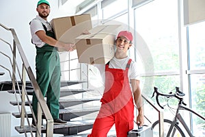 Male movers carrying boxes