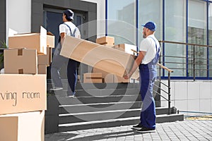 Male movers carrying shelving unit photo