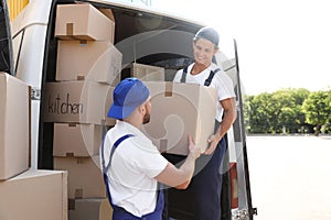 Male movers unloading boxes