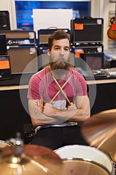 Male musician with cymbals at music store