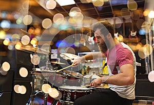 Male musician playing cymbals at music store