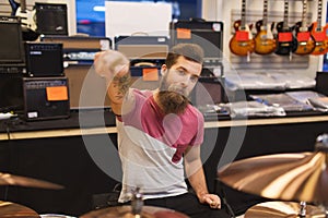 Male musician playing cymbals at music store