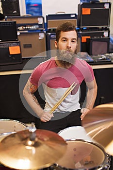 Male musician playing cymbals at music store