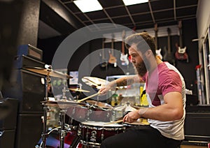 Male musician playing cymbals at music store