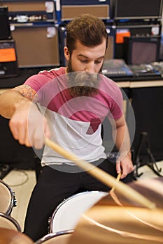 Male musician playing cymbals at music store