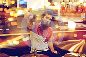 Male musician playing drum kit at music store