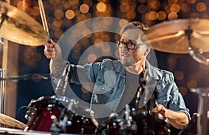 Male musician playing drums and cymbals at concert