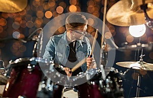 Male musician playing drums and cymbals at concert