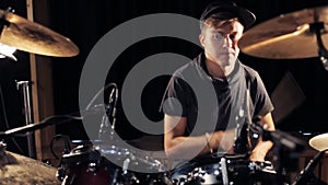 Male musician playing drums and cymbals at concert