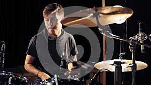 Male musician playing drums and cymbals at concert