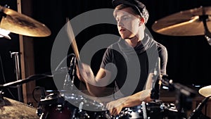 Male musician playing drums and cymbals at concert