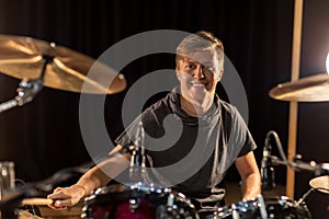 Male musician playing drums and cymbals at concert