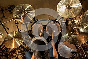 Male musician playing drums and cymbals at concert