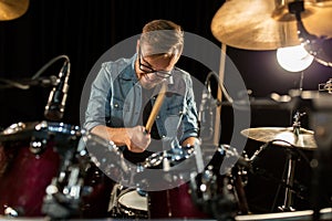 Male musician playing drums and cymbals at concert