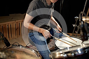 Male musician playing drums and cymbals at concert