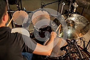 Male musician playing drums and cymbals at concert